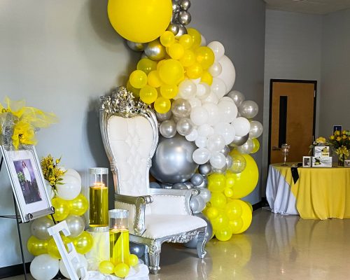 event management, event decoration, Throne chair, vase floating candles, decor, decoration, framed photo, retirement, birthday celebration, balloon, balloon decorations, balloon decor, balloon backdrop, balloon decoration on wall, white balloon wall, yellow balloon wall, throne chair, balloon arch, balloon circle, photo balloon backdrop, optic station, photo station, silver & white chair, silver throne chair, white throne chair, memory table, card table, table setup, memorial table, card table decor, yellow table decor, yellow round table decor, card box, card box table, yellow flowers, yellow roses, card table decor with flowers, event planner raleigh nc,event planning companies raleigh nc, durham nc, cary nc, apex nc,